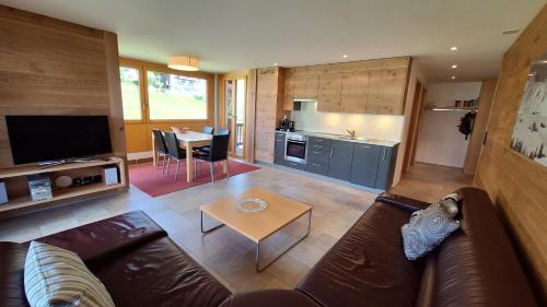 a living room with a couch and a table at Haus Bella Vista in Riederalp