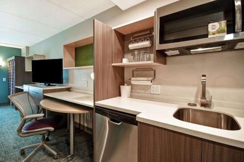 a kitchen with a sink and a desk at Home2 Suites By Hilton Atlanta Marietta, Ga in Marietta