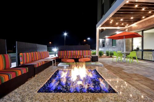 a fire pit in the middle of a patio at night at Home2 Suites By Hilton Birmingham/Fultondale, Al in Fultondale