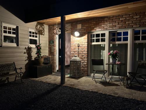 a front porch of a house at night at Le Nid Douillet in Theux
