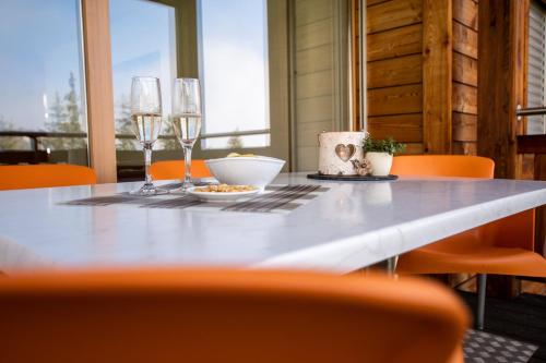 a dining room table with wine glasses and a bowl at Haus Bella Vista in Riederalp