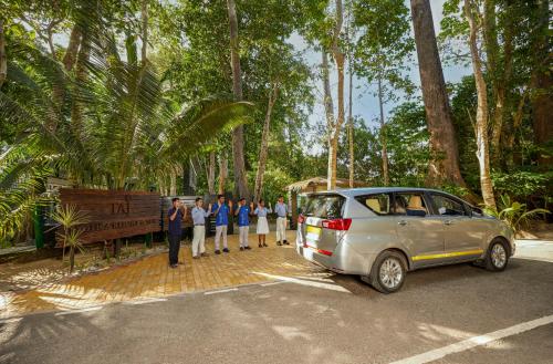a group of people standing next to a car at Taj Exotica Resort & Spa, Andamans in Havelock Island