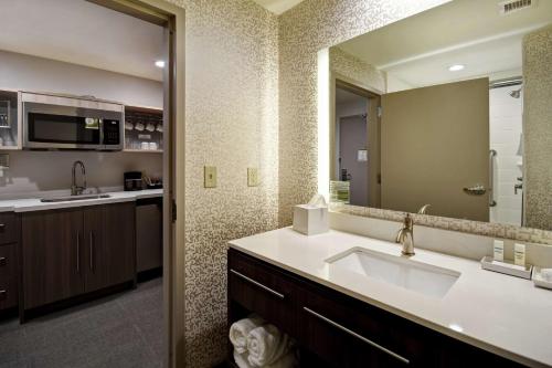 a bathroom with a sink and a large mirror at Home2 Suites By Hilton Birmingham/Fultondale, Al in Fultondale