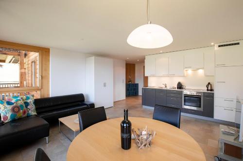 a kitchen and living room with a table and a couch at Haus Bella Vista in Riederalp