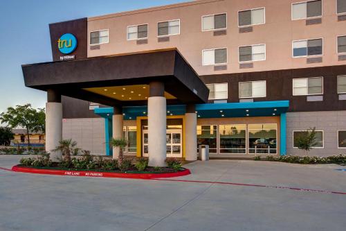 a building with a sign on the front of it at Tru By Hilton Grand Prairie in Grand Prairie