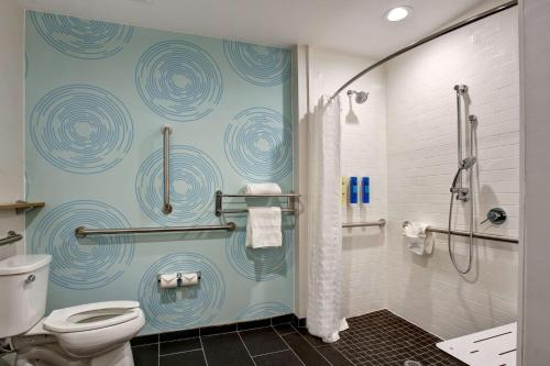 a bathroom with a toilet and a shower stall at Tru By Hilton Grand Prairie in Grand Prairie