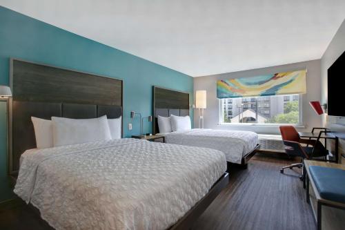 a hotel room with two beds and a window at Tru By Hilton Grand Prairie in Grand Prairie
