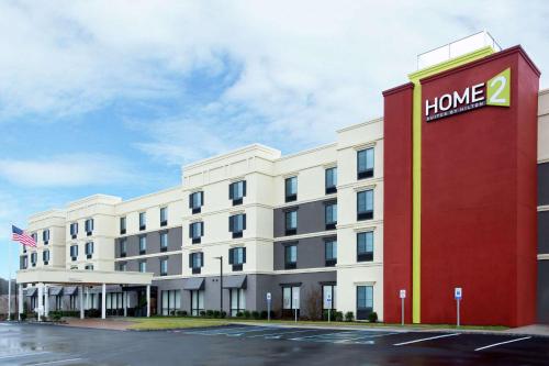 a hotel building with a sign that reads home at Home2 Suites by Hilton Long Island Brookhaven in Yaphank