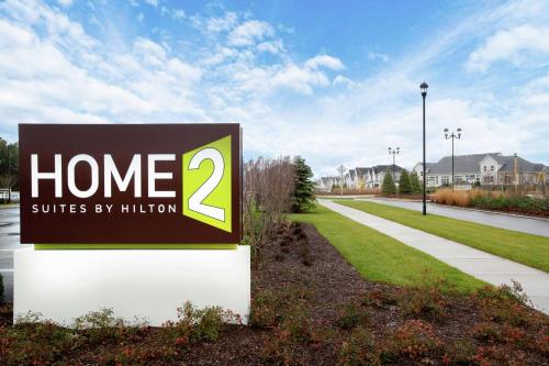 a sign that reads home suites by hilton at Home2 Suites by Hilton Long Island Brookhaven in Yaphank