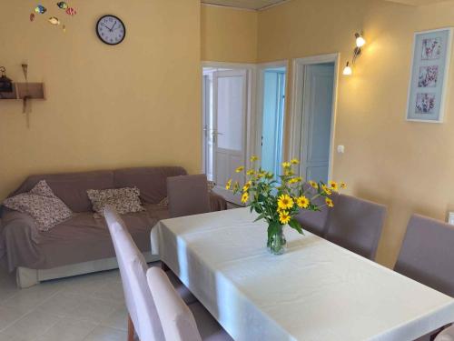 a living room with a table with a vase of flowers on it at Apartment Siofok, Lake Balaton 1 in Siófok