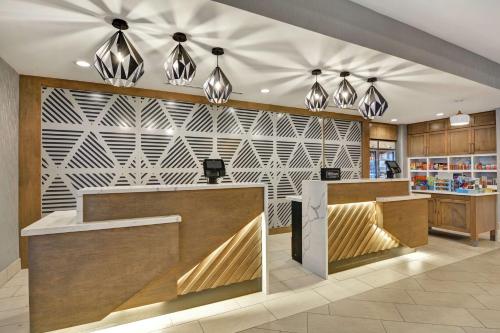 a lobby of a store with a patterned wall at Homewood Suites By Hilton Lynchburg in Lynchburg
