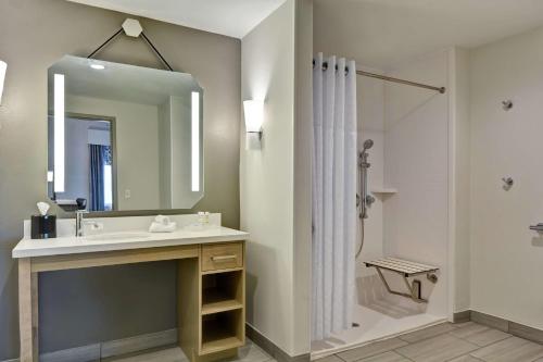 a bathroom with a sink and a shower with a mirror at Homewood Suites By Hilton Lynchburg in Lynchburg