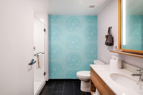 a bathroom with a toilet and a sink at Tru By Hilton Greenville in Greenville