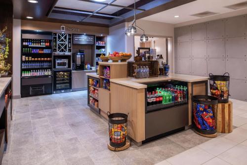 a grocery store with a counter with drinks in it at Hilton Garden Inn Kansas City Airport Mo in Kansas City