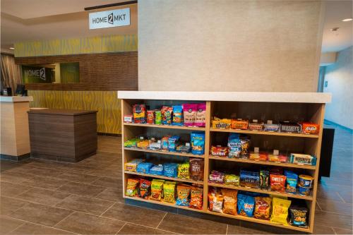 a food section of a store with a shelf of food at Home2 Suites Bakersfield in Bakersfield
