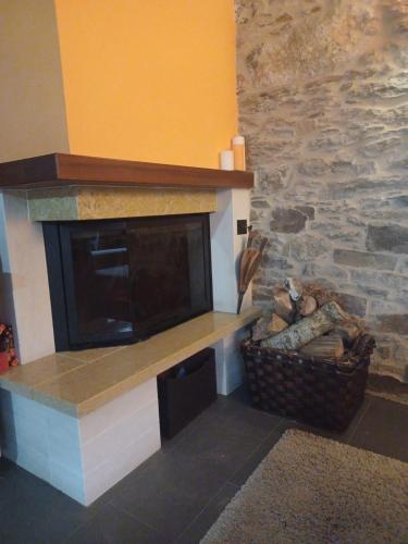 a fireplace in a living room with a brick wall at Casanova1914 in Villatuge
