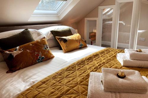 a bedroom with a large bed with pillows on it at Barf Fell House in Bassenthwaite Lake