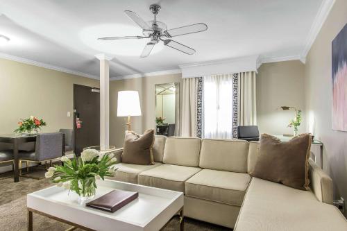 a living room with a couch and a table at The Burgundy Hotel, Tapestry Collection by Hilton in Little Rock