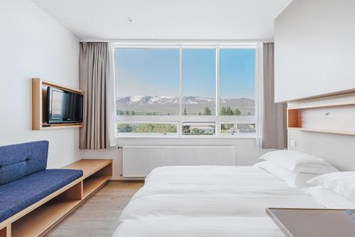 a hotel room with two beds and a window at Akureyri - Berjaya Iceland Hotels in Akureyri