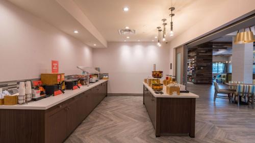 a restaurant with two counters and a table with chairs at Hampton Inn Riverside Downtown in Riverside