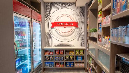 a grocery store aisle with a treats sign on the wall at Hampton Inn Riverside Downtown in Riverside
