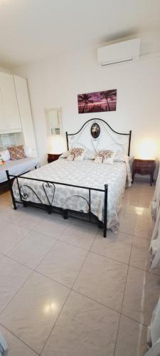 a bedroom with a bed in a white room at Le Terrazze Rooms & Studios in Ferrara