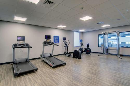 a gym with treadmills and exercise equipment in a room at Hampton Inn & Suites Portland West in Portland