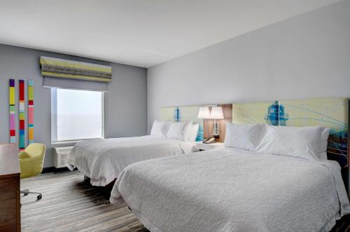 a hotel room with two beds and a window at Hampton Inn & Suites Portland West in Portland