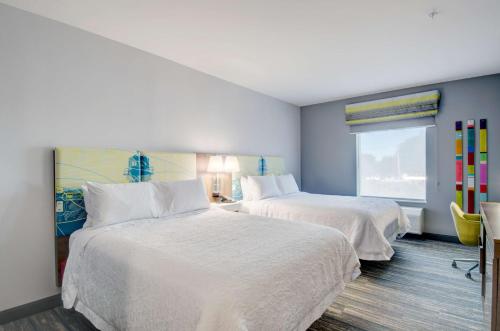 a hotel room with two beds and a window at Hampton Inn & Suites Portland West in Portland