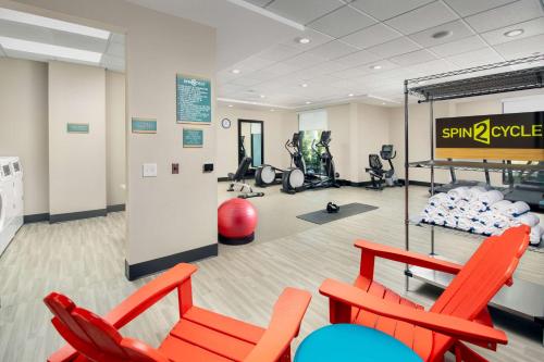 a gym with red chairs and exercise equipment at Home2 Suites By Hilton St. Augustine I-95 in Saint Augustine