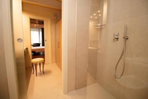 a bathroom with a shower with a glass door at Olivi Hotel & Natural Spa in Sirmione