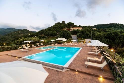 a swimming pool with lounge chairs and umbrellas at Villa Ginevra Resort Agrituristico in Ficarra