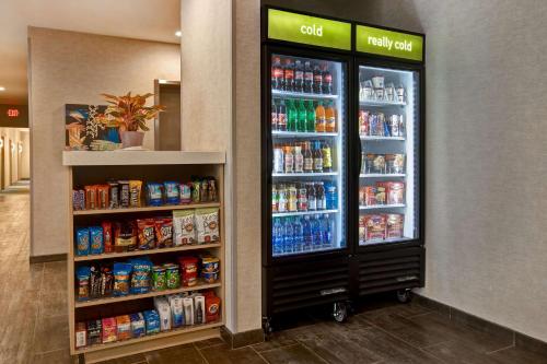 a soda machine in a grocery store with drinks at Home2 Suites By Hilton Charlotte Northlake in Charlotte