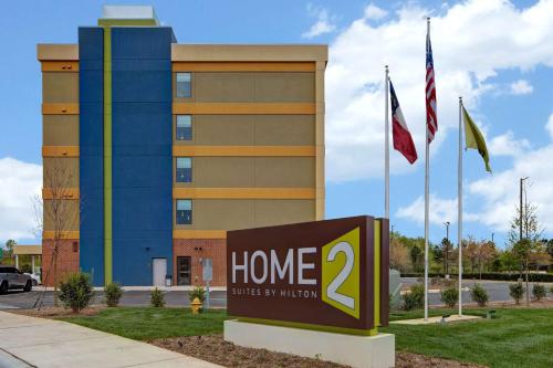 a home sign in front of a building at Home2 Suites By Hilton Charlotte Northlake in Charlotte