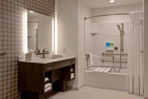a bathroom with a sink and a shower at Home2 Suites By Hilton Charlotte Northlake in Charlotte