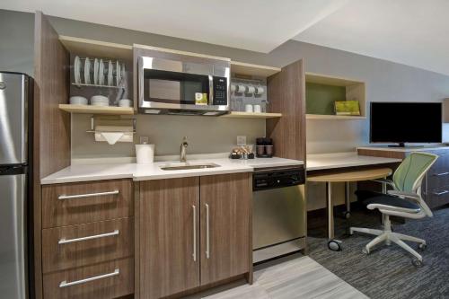 a kitchen with a sink and a microwave at Home2 Suites By Hilton Taylor Detroit in Taylor