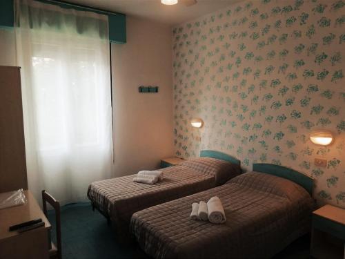 Postel nebo postele na pokoji v ubytování Hotel Roma