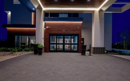 a building with a large glass door at night at Hampton Inn & Suites Duncanville Dallas, Tx in Duncanville