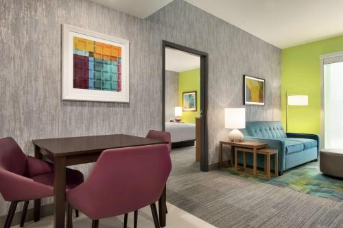 a living room with a table and a couch at Home2 Suites By Hilton Dayton/Beavercreek, Oh in Beavercreek