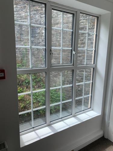 a window in a room with four windows at The Apartment, Bridge House in Laxey