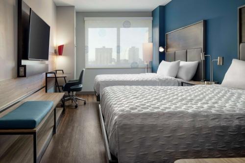 a hotel room with two beds and a window at Tru By Hilton Denver Downtown Convention Center in Denver