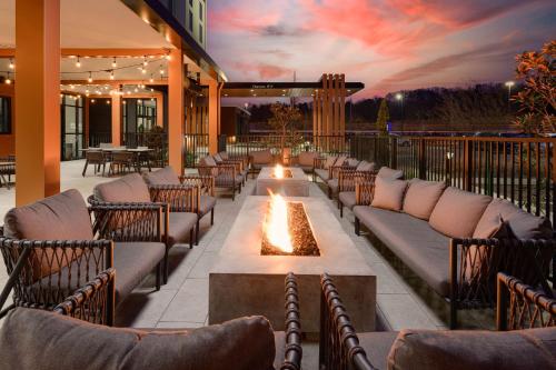 an outdoor patio with couches and a fire pit at Hilton Garden Inn Knoxville Papermill Drive, Tn in Knoxville