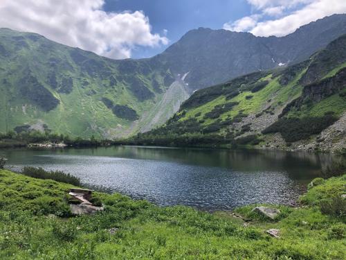 a lake in the middle of a valley with mountains at Apartmán 111 Vila Zuberec in Zuberec