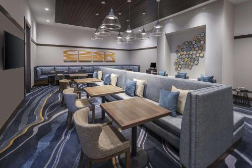 a row of tables and couches in a restaurant at Homewood Suites by Hilton Boston Woburn in Woburn