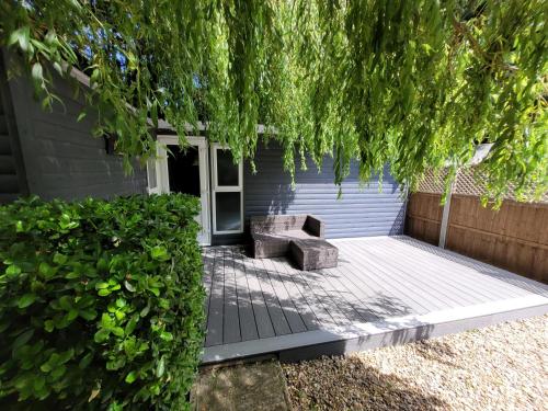 a patio with a bench in front of a house at Willow Inn in Kent