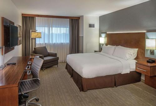 a hotel room with a large bed and a desk at Doubletree By Hilton Omaha Southwest, Ne in Omaha