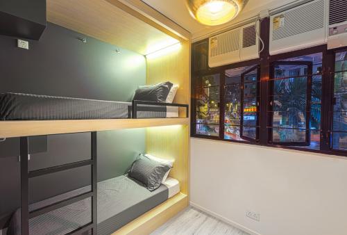 a room with bunk beds and a window at The Mahjong in Hong Kong