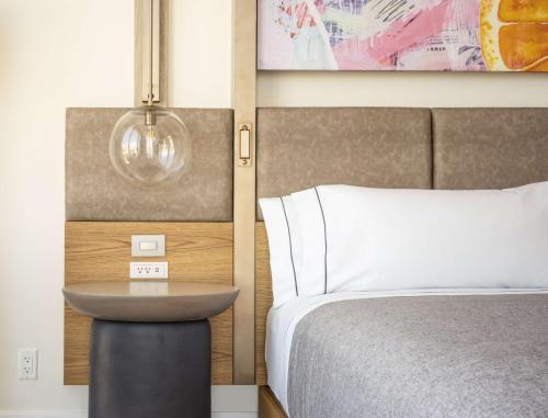 a bedroom with a bed and a table next to it at Canopy West Palm Beach - Downtown in West Palm Beach