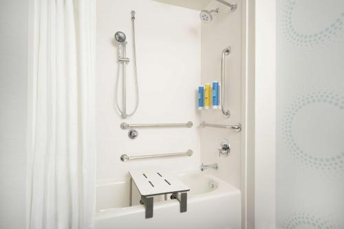 a bathroom with a shower and a bath tub with a sink at Tru By Hilton Kennesaw, Ga in Kennesaw