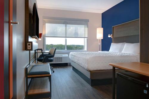 a hotel room with a bed and a window at Tru By Hilton Columbia Greystone in Columbia